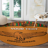 Orange round carpet rug with eagle emblem, 'YOUR TEXT' banner, and kente border stripes