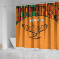 Orange shower curtain panel with kente top band and Copper Queens eagle emblem