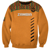 Orange crewneck football sweatshirt with kente pattern yoke and ZAMBIA logo on front