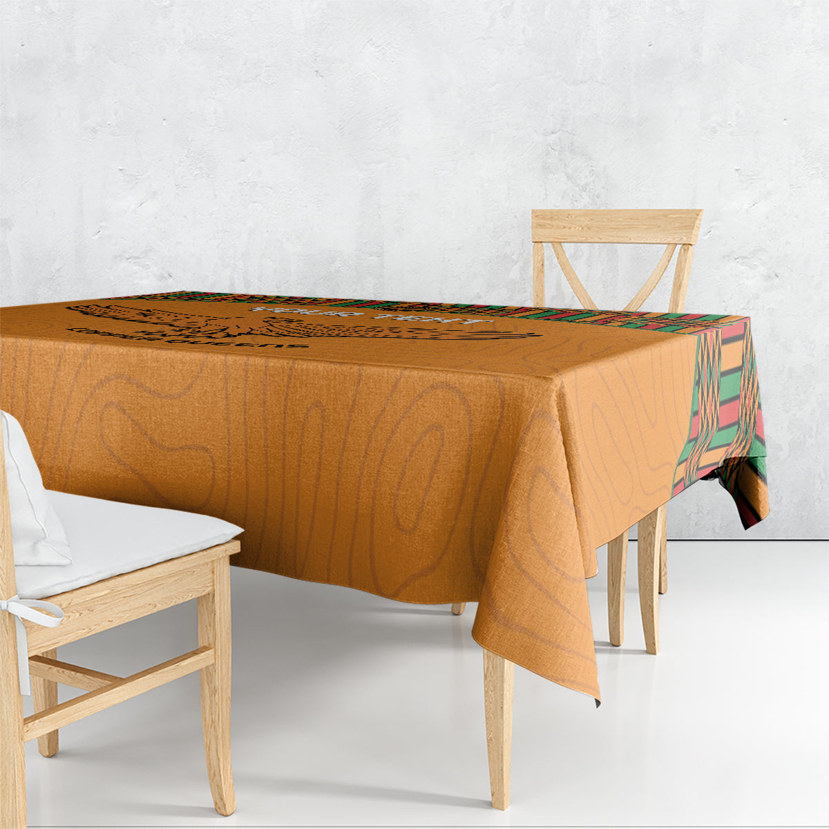 Orange football tablecloth with kente-pattern edge on rectangular dining table