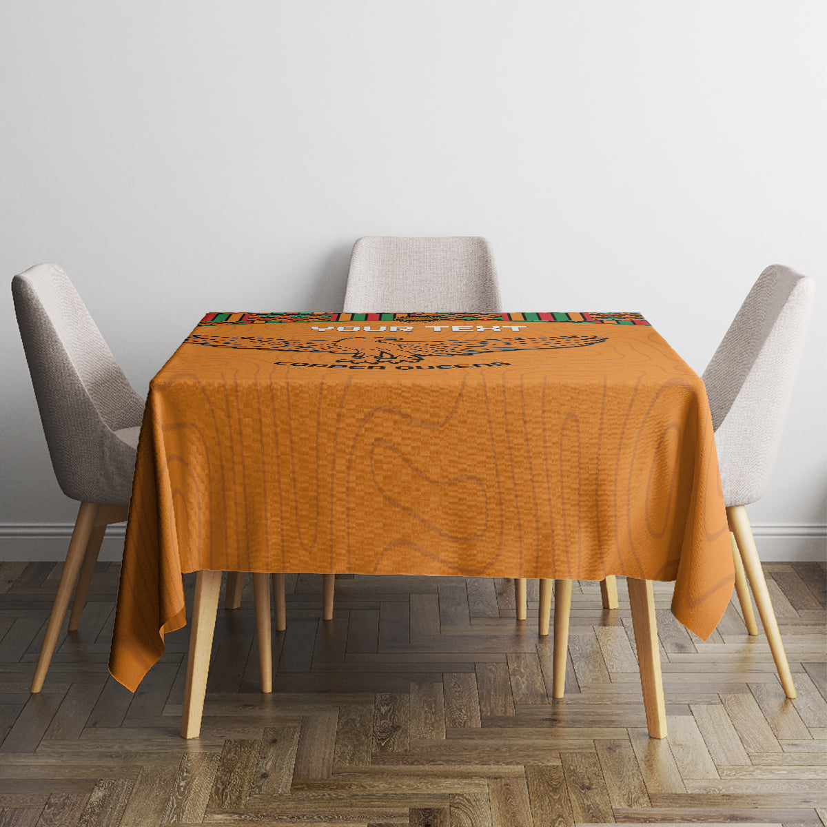 Orange football tablecloth with kente top panel and eagle graphic on small round table