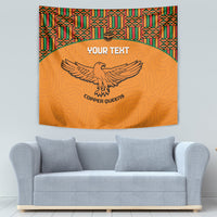 Orange football tapestry with kente border, eagle emblem, custom text centered