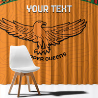 Orange curtain close-up with winged bird graphic and custom text across the center