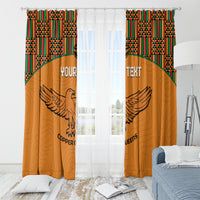 Orange window curtains with kente-pattern valance and winged bird plus custom text