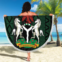 Round beach blanket held up, Nigeria Super Falcons design in green and black with white fringed border
