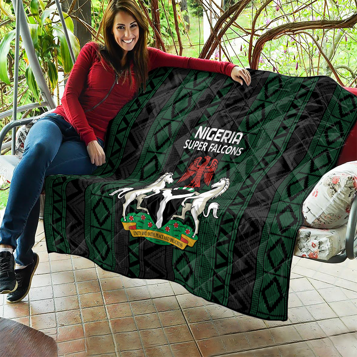 Nigeria Super Falcons quilt laid out on patio, black and green geometric pattern