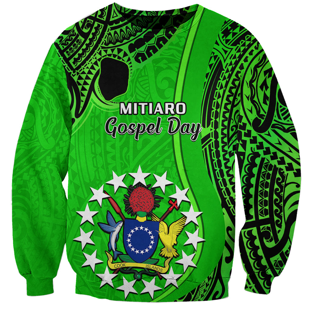 Green unisex sweatshirt with Mitiaro Gospel Day text and tribal crest graphic