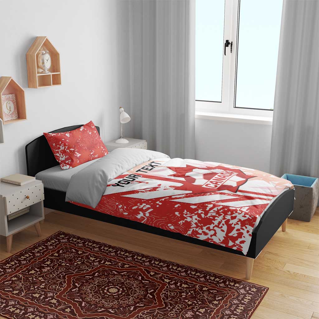 Red and white Canada soccer bedding set on bed with matching pillows and crest