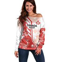 Red and white off-shoulder Canada Soccer sweatshirt with long sleeves and front graphic