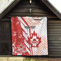 Red and white Canada soccer quilt hanging on wall, showing maple leaf and “Your Text”
