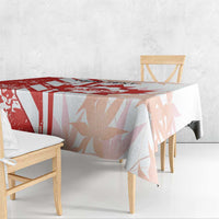 Canada-themed tablecloth in red and white, draped over a wooden dining table