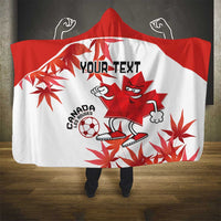 Red-and-white hooded blanket with Canada soccer mascot and maple leaf print