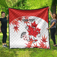 Red and white quilt blanket featuring Canada mascot, soccer ball, maple leaves, and “YOUR TEXT”