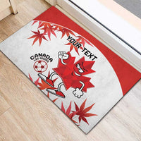 Red and white Canada mascot rubber doormat with “YOUR TEXT” and maple leaf graphics