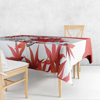 White and red tablecloth with large maple leaf and soccer-themed mascot print