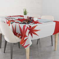 Red and white maple leaf tablecloth with mascot soccer graphic on table surface