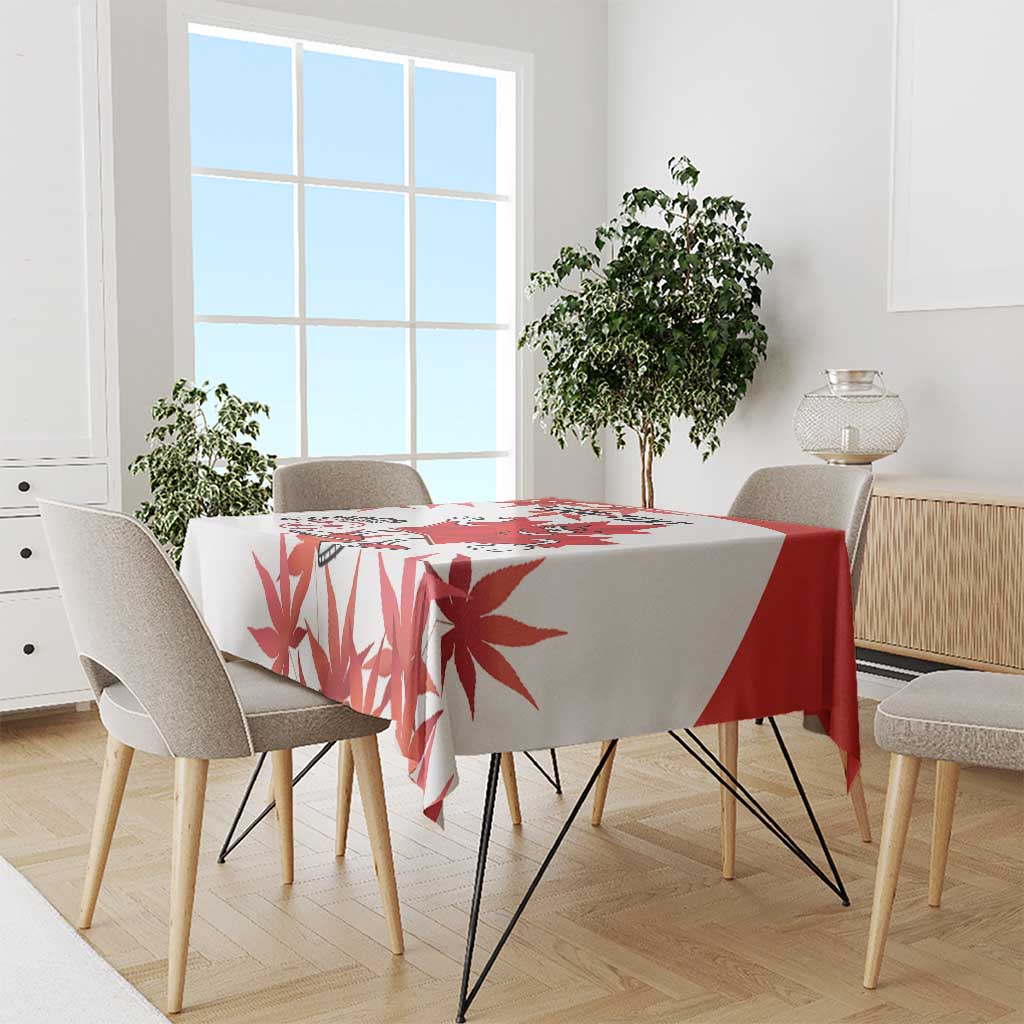 Red and white maple leaf tablecloth draped over dining table, soccer-themed print