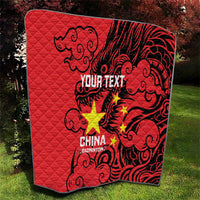 Red quilt with black dragon motif, yellow stars, and your text printed in the middle.