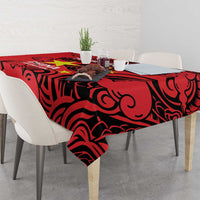 Red badminton tablecloth with black dragon scroll design over dining table