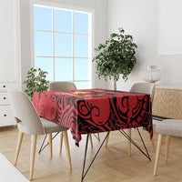Red badminton tablecloth with black dragon swirls across the table surface