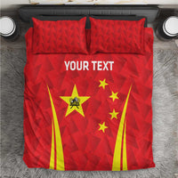 Red bedding set with triangle pattern, China emblem and stars, and yellow striped accents.