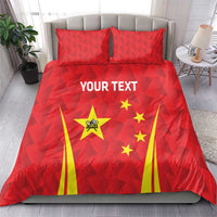 Red bedding set with triangular pattern, China emblem and stars, and yellow fan stripes across duvet.