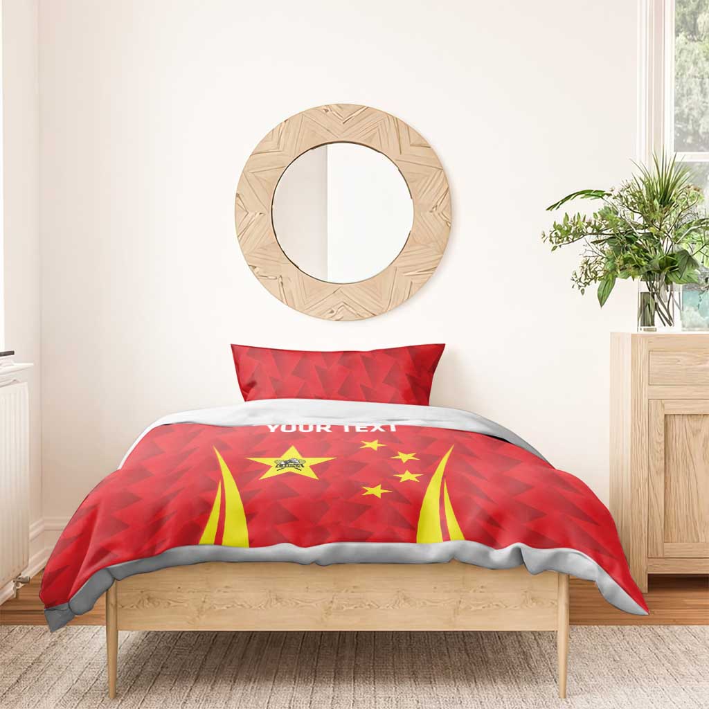 Red duvet with China star emblem, yellow stripes, and gray trim edging; two red pillows.