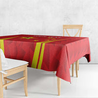 Red tablecloth with yellow stripe graphics and geometric pattern draped on a table