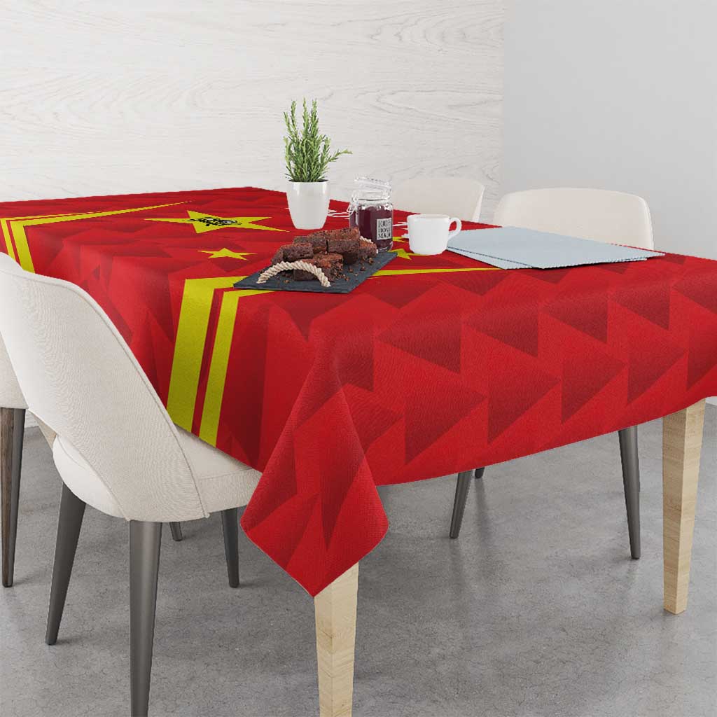 Red badminton tablecloth with China-themed print and yellow stripes on a dining table