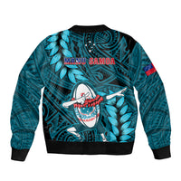 Turquoise rugby bomber jacket with MANU SAMOA lettering and leaf-pattern mascot graphic