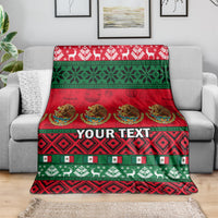 Red and green Christmas throw blanket with holiday motifs and centered custom text panel