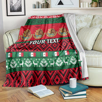 Red Christmas blanket with green borders, festive symbols, medallions, and custom text