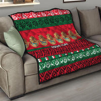 Red and green quilt draped on sofa with Feliz Navidad stripes and "YOUR TEXT".