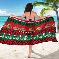Red and green Mexican Christmas sarong draped on model, 'YOUR TEXT' across center.