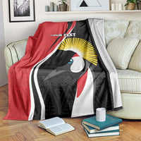 Red, black, and gray custom rugby blanket with bird-like mask design, yellow sunburst, and text