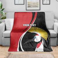Red and black rugby custom blanket on gray sofa, featuring white mask artwork and yellow rays