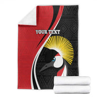 Folded red and black custom blanket with white mask graphic, yellow sunburst, and centered text