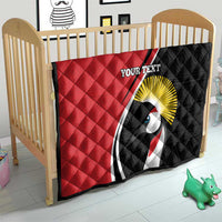 Crib quilt in red and black with crane emblem, sunburst, and “YOUR TEXT”