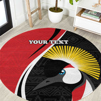 Round red rug with bird head artwork, black pattern, yellow rays, and 'YOUR TEXT'