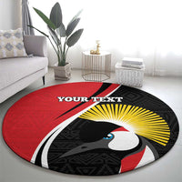 Round red rug with black geometric pattern, bird head, yellow rays, and 'YOUR TEXT'