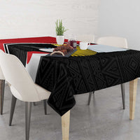Black tablecloth with geometric pattern, white stripe, and crane emblem center