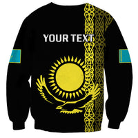 Black unisex sweatshirt with yellow sun-and-eagle graphic, gold pattern side panel, turquoise cuffs