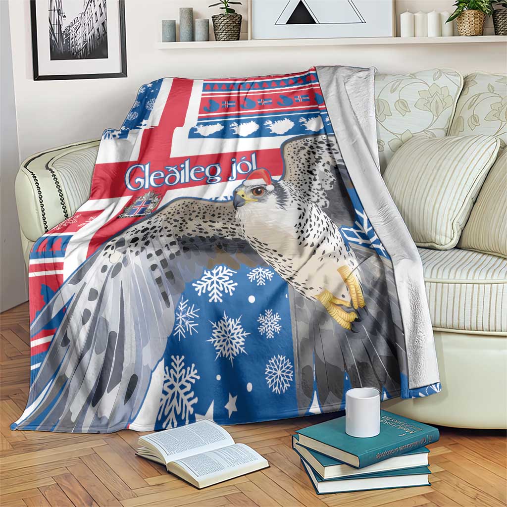 Blue Christmas blanket with red white stripes, snowflakes, and gyrfalcon graphic