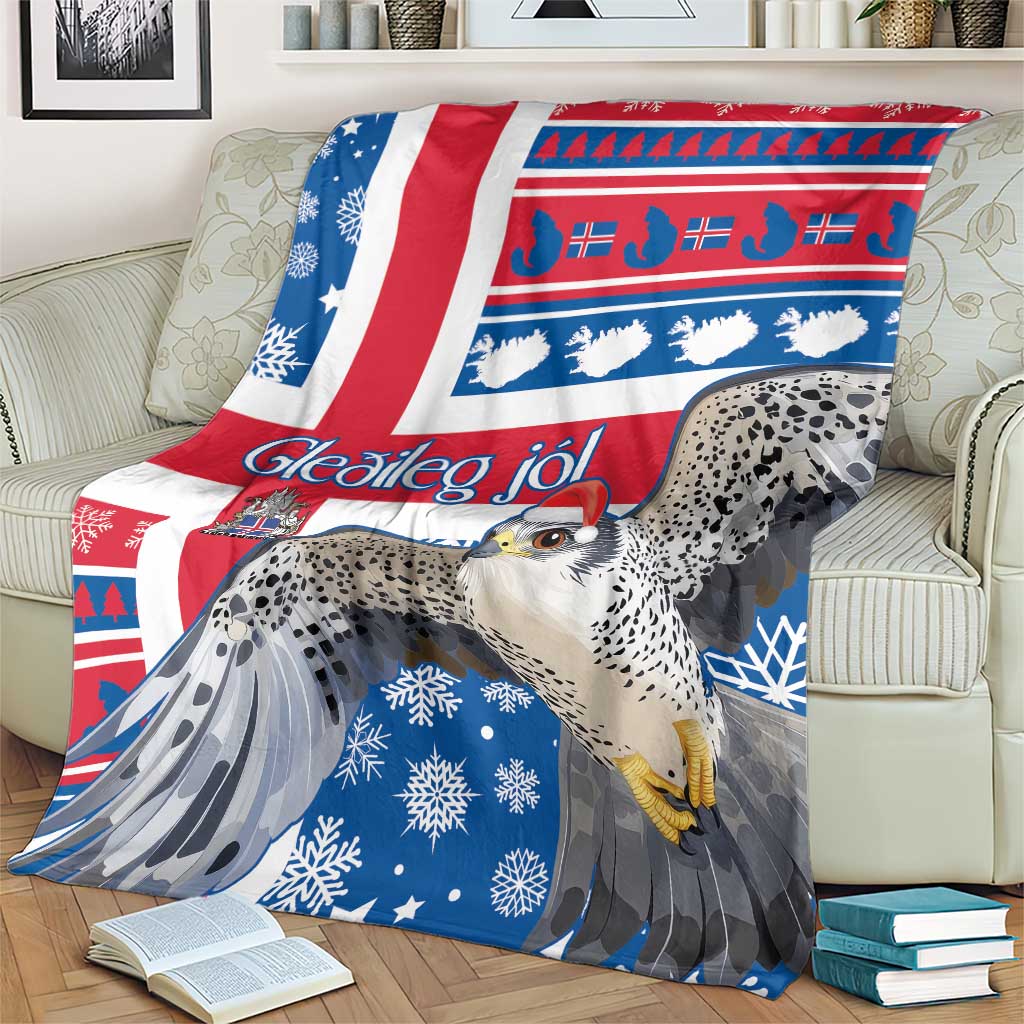 Blue Christmas blanket on sofa with gyrfalcon, white snowflakes, and red Nordic stripes