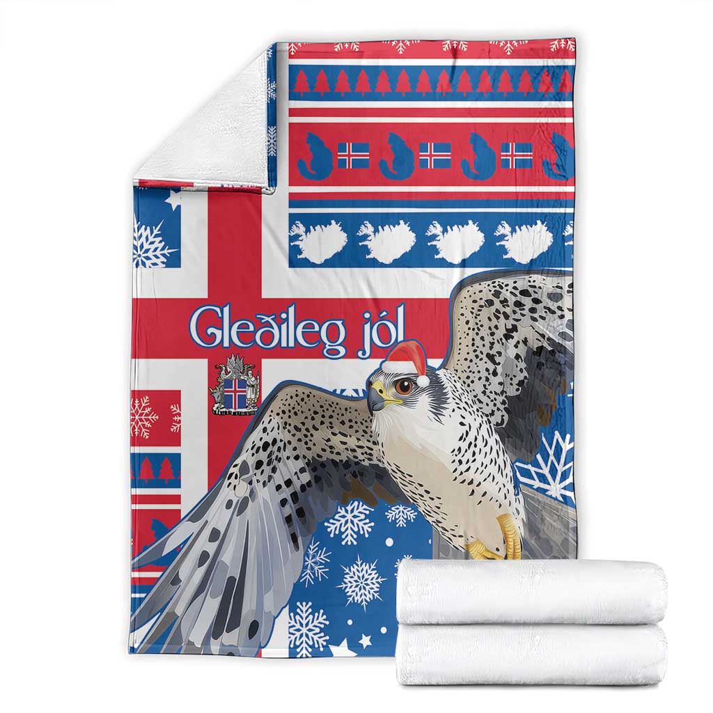 Blue and red Christmas blanket with gyrfalcon and snowflakes, with folded white towels