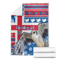 Blue and red Christmas blanket with gyrfalcon and snowflakes, with folded white towels