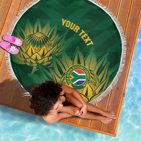 Green circular cricket beach blanket with white fringe, 'YOUR TEXT' and leaf emblem