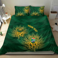 Green duvet cover and two matching pillows with gold crest and 'YOUR TEXT' design