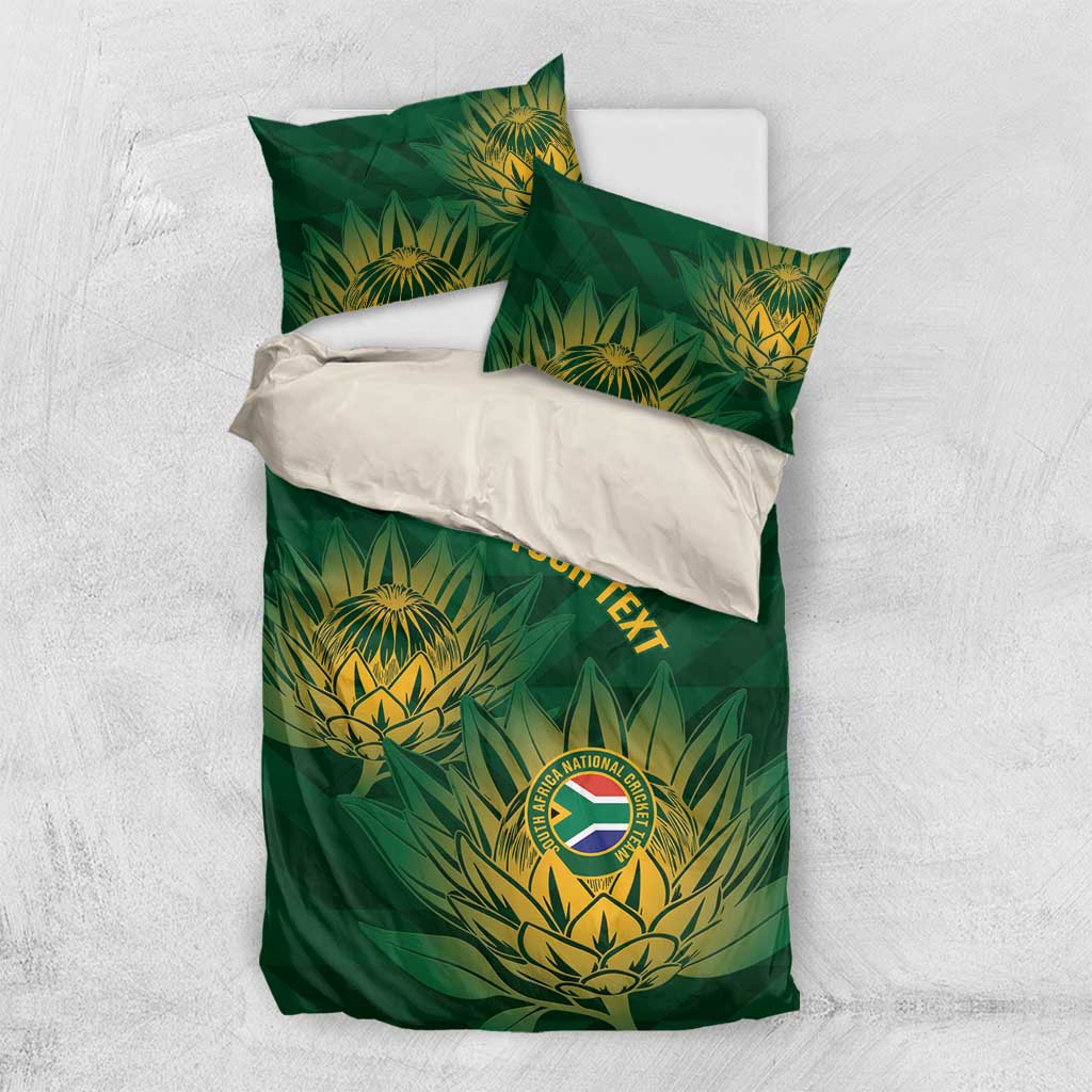 Green bedding set with gold leaf crest pattern and 'YOUR TEXT' across the duvet