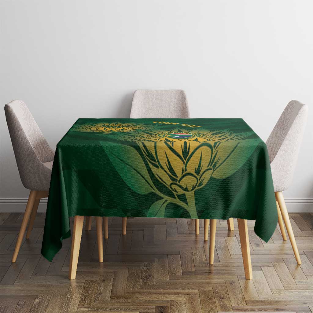 Green square tablecloth featuring gold foliage and cricket crest centered on the tabletop.